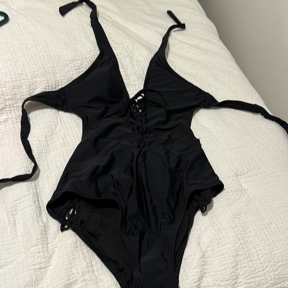 Black one piece bathing suit with open back and ties